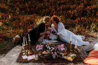 A couple having a romantic picnic for their wedding