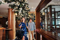 A couple walking into The Club Hotel