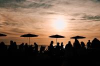 sunset in St. Ouen's Bay with a group of people silhouetted enjoying the evening.