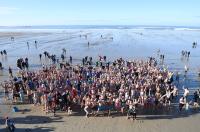 A crowd of people on St Ouen's beach aking part in the Christmas Day Swim