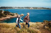 Couple walking on a cliff path above the sea