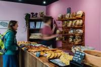 Woman serving a customer at a bakery