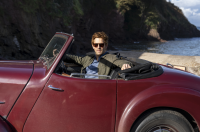 Bergerac star Damien Molony poses in the burgundy Triumph Roadster which appeared in the original Bergerac series
