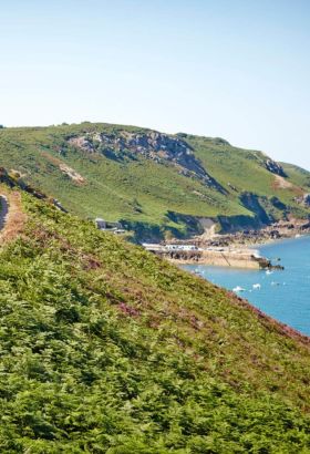 two people walking a north coast cliff path