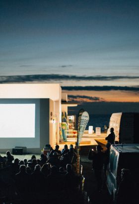 Outdoor film screening by the beach