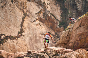 Swim Run athletes climbing down rockface