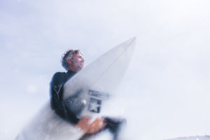 Surfer holding surf board