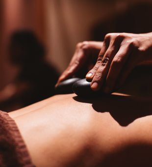 A lady having a hot stone massage