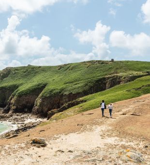 Couple walking along the Jersey Tidal Trail, Plemont Jersey