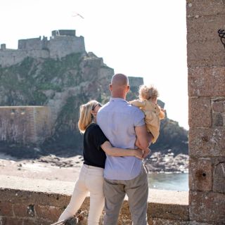 family overlooking castle in window frame