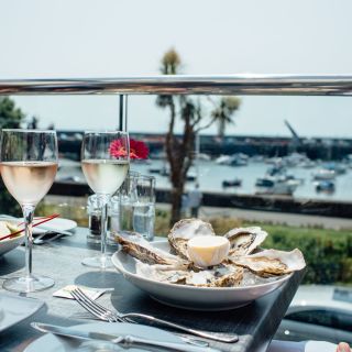 Gorey harbour view from the terrace at Sumas with oysters and drinks on the table