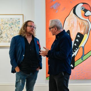 Men talking at an exhibition