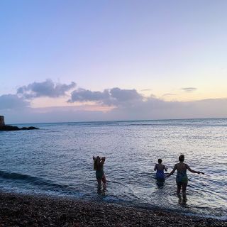 Girls swimming in the sea at sunrise