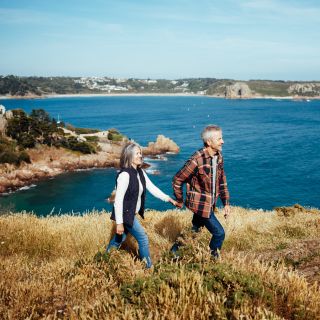Couple walking on a cliff path above the sea