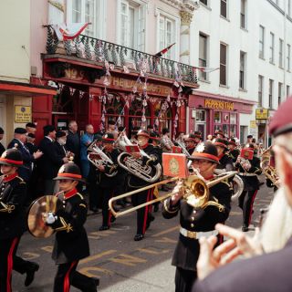 Man playing trumpet in street for Liberation