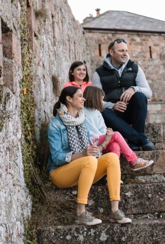 Family sat on steps at Fort Leicester