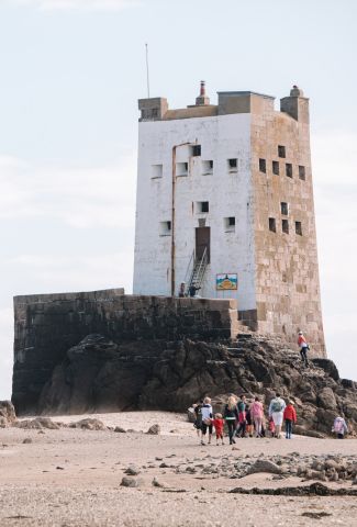 Family walking at low tide, Seymour Tower Jersey