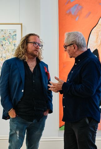 Men talking at an exhibition