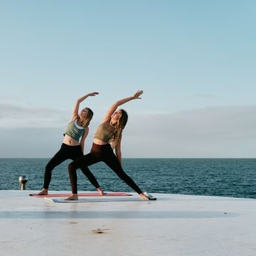 Two women do yoga at Harve de Pas Jersey