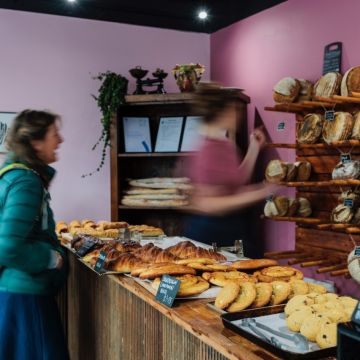 Woman serving a customer at a bakery