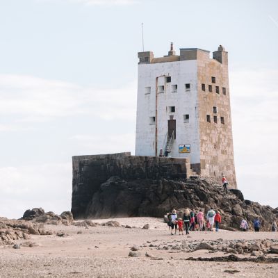 Family walking at low tide, Seymour Tower Jersey