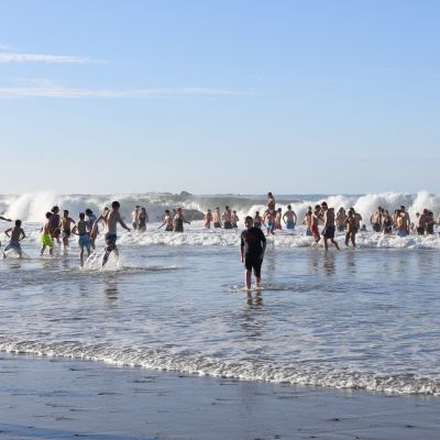 A group of people in the water at St. Ouen