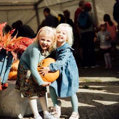 Young girls holding a pumpkin