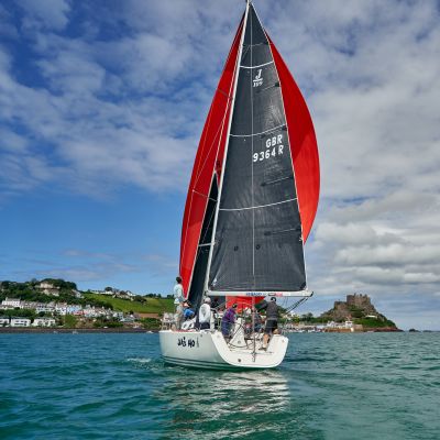 Sailing boat in Grouville Bay Jersey, with view of Mont Orgueil Castle