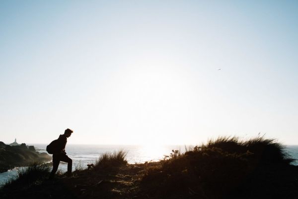 Person walking cliff path by Corbiere