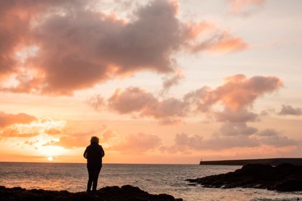 Person standing at Fliquet overlooking the sea