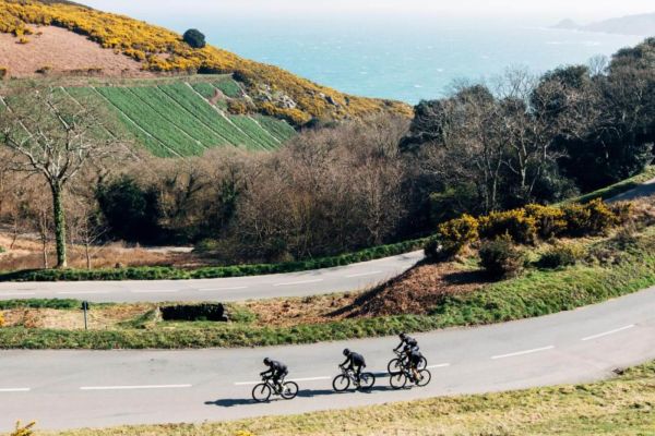 Cyclists going down a winding lane