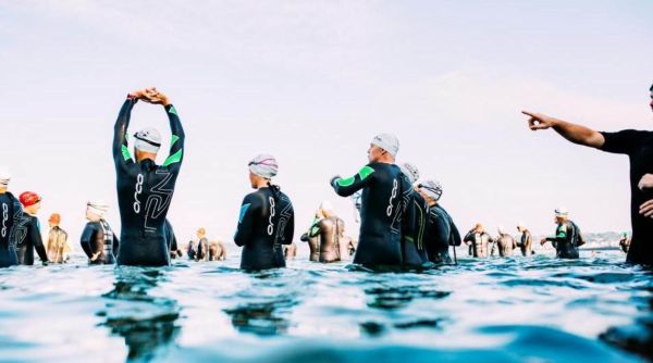 Racers stretching in water before event