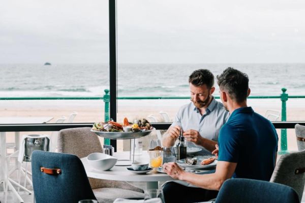 People sat al fresco eating fresh seafood