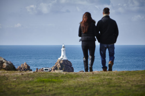 A couple walking at Corbiere Lighthouse