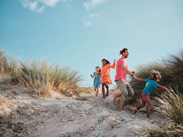 A family having fun on the sand dunes