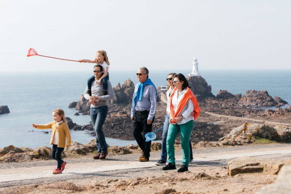 A family walking in front of Corbière Lighthouse