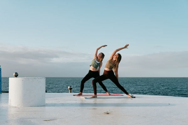 Two women do yoga at Harve de Pas Jersey
