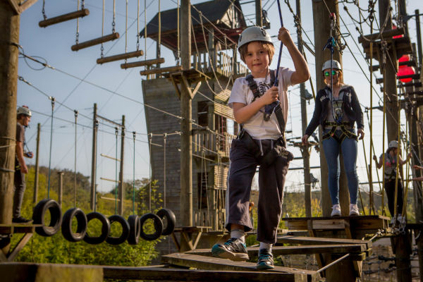 A little boy on the Aerial Trekking at Valley Adventure Centre, Jersey