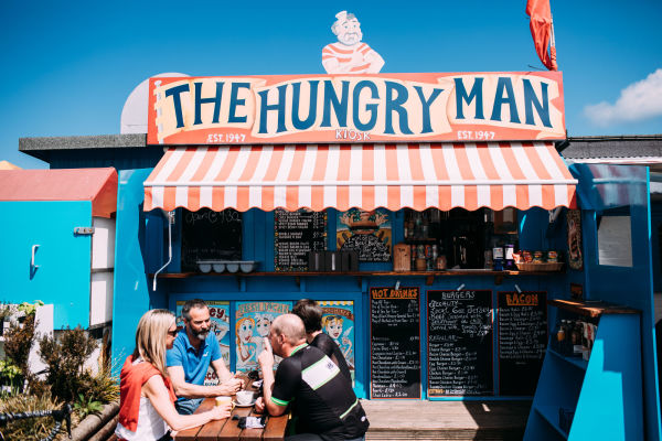 Group of cyclist sitting at The Hungry Man Cafe in Rozel, Jersey