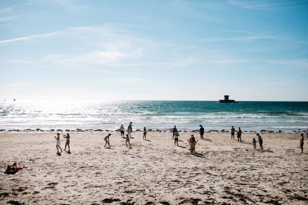 People playing on the sand at St. Ouen