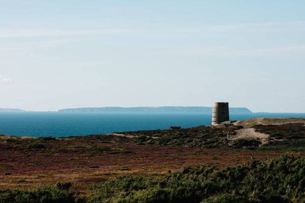 A view of Guernsey on the horizon with Le Lande bunker in the foregrounde