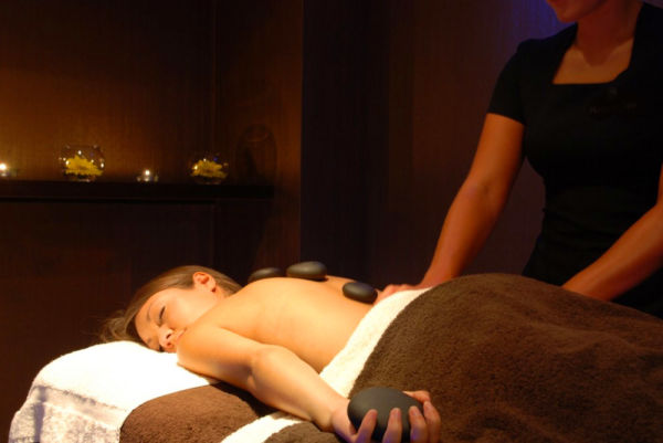 A lady having a hot stone massage at the Grand Hotel