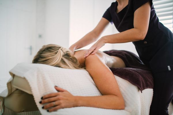 A lady having a massage at the Cottage Garden Spa at Longueville Manor