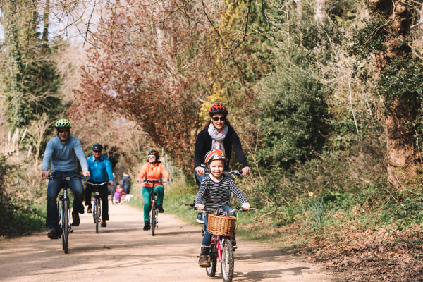 A family cycling along the Railway Walk