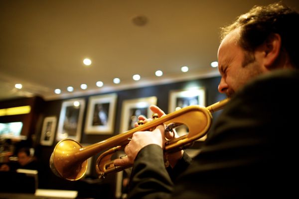 A man playing trumpet in the Savoy hotel