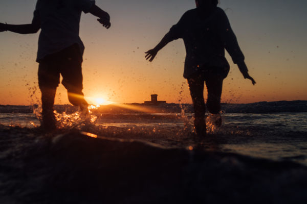 People at sunset having fun at St Ouens Bay