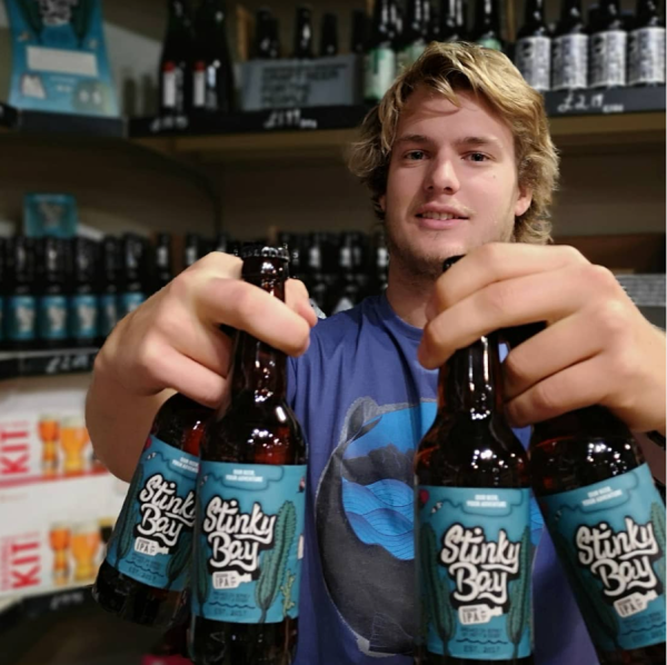Young man holding bottles of beers
