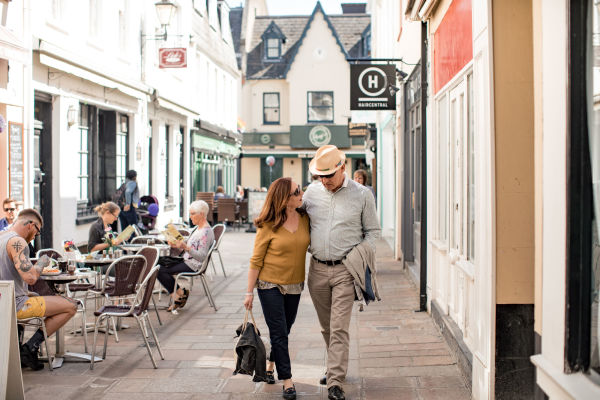 Older couple walking the back streets of a pretty town