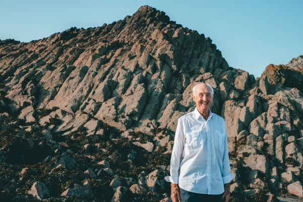 Ralph Nichols standing in front of rocks at La Crête