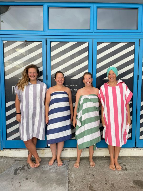 Women wearing stripy towels after sea swimming